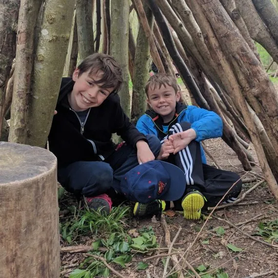 boys in a forest den