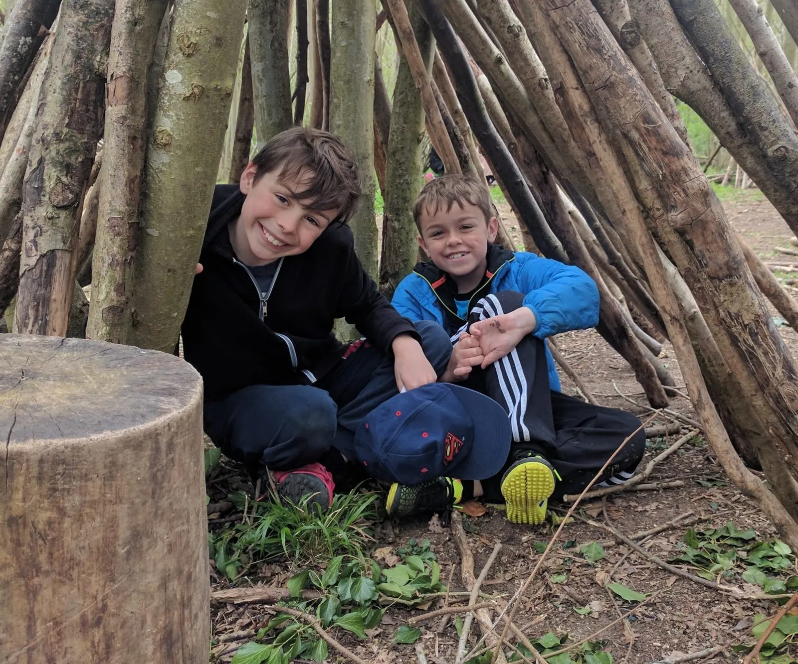 boys in a forest den